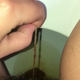 A rear close-up of a very cute girl's ass as a short hang drops, then she pulls a tampon. Brief clip. Filmed from a between the legs perspective. Vertical format video. About a minute.